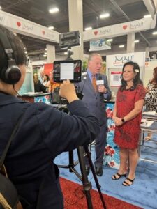 Camera, man and woman facing with microphone