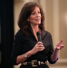 woman talking into microphone in hand