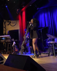 woman singing on stage
