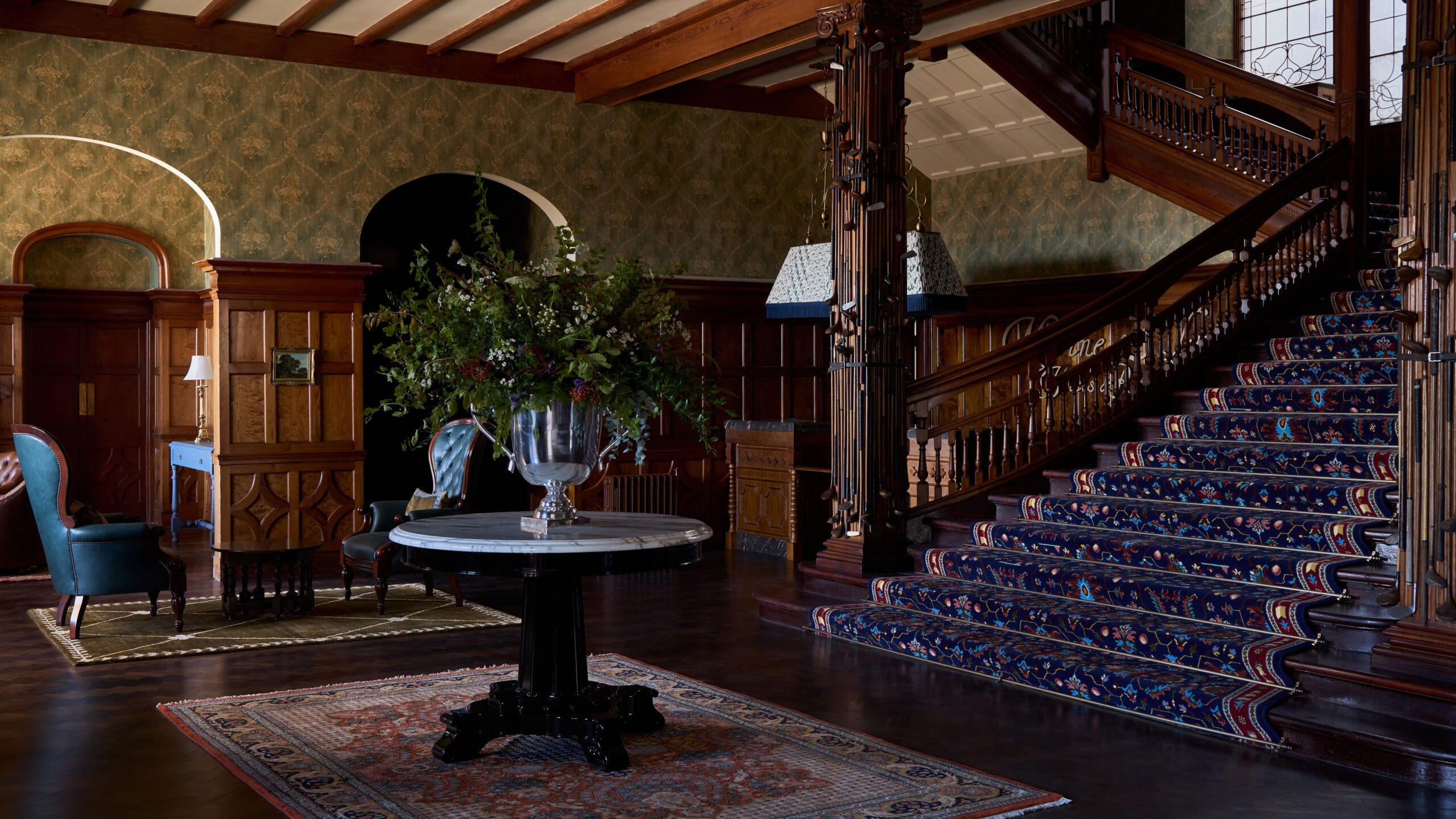 An entryway with a grand staircase in the new and renovated Dornoch Station