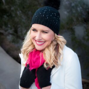 woman wearing pink scarf, black beanie and gloves