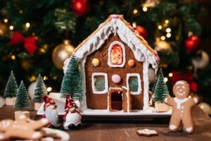 Christmas,House,Made,From,Ginger,Cookies,With,Ginger,Man,Outside