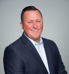 man in blue suit smiling