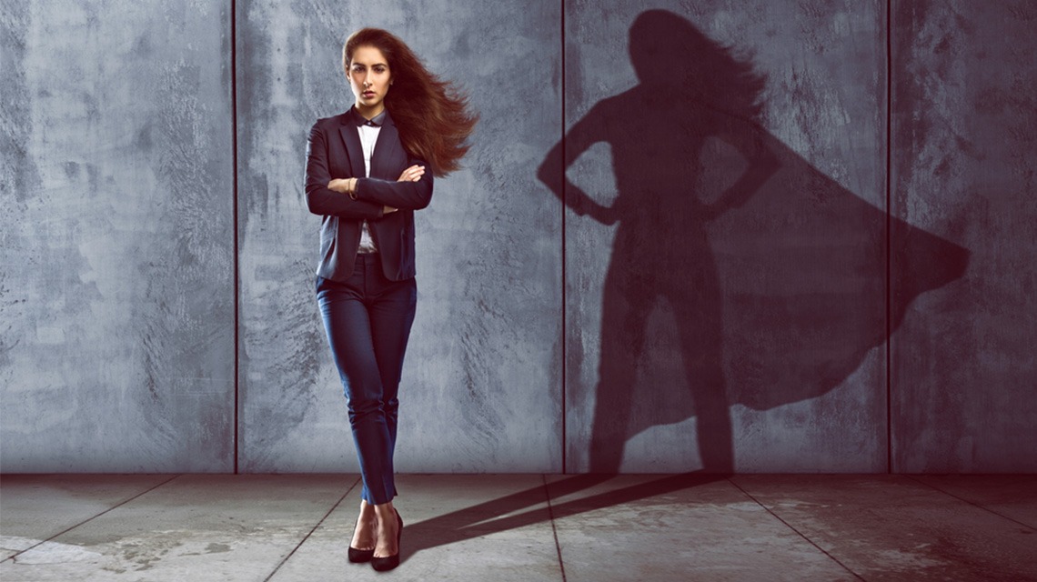 woman standing with superwoman shadow behind her
