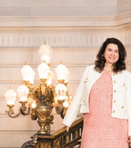woman in pink dress and white coat