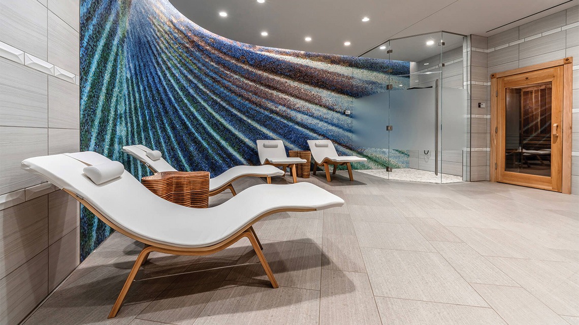 spa room with four white lounge chairs