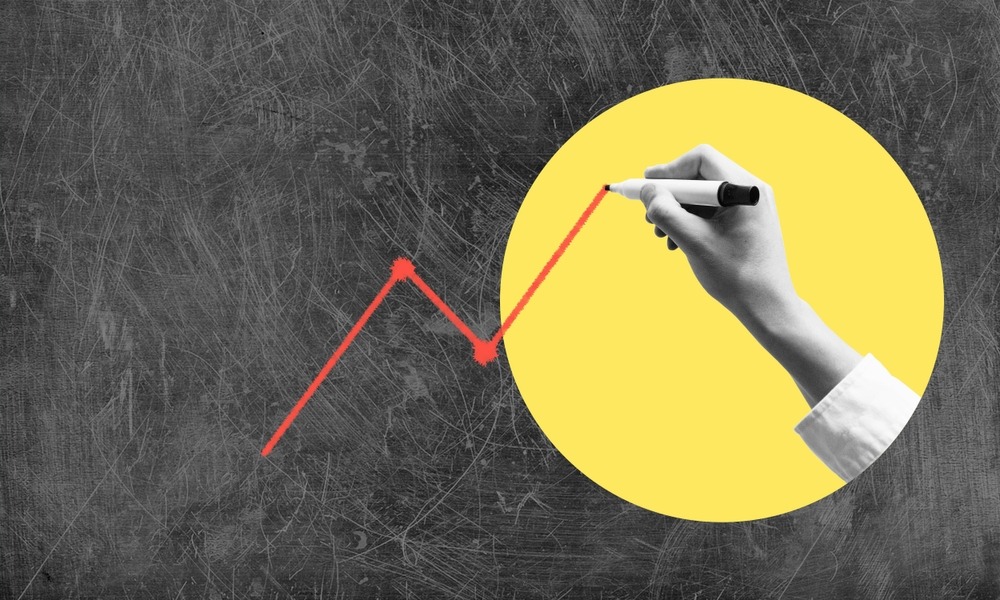 Hand with marker draws upward arrow