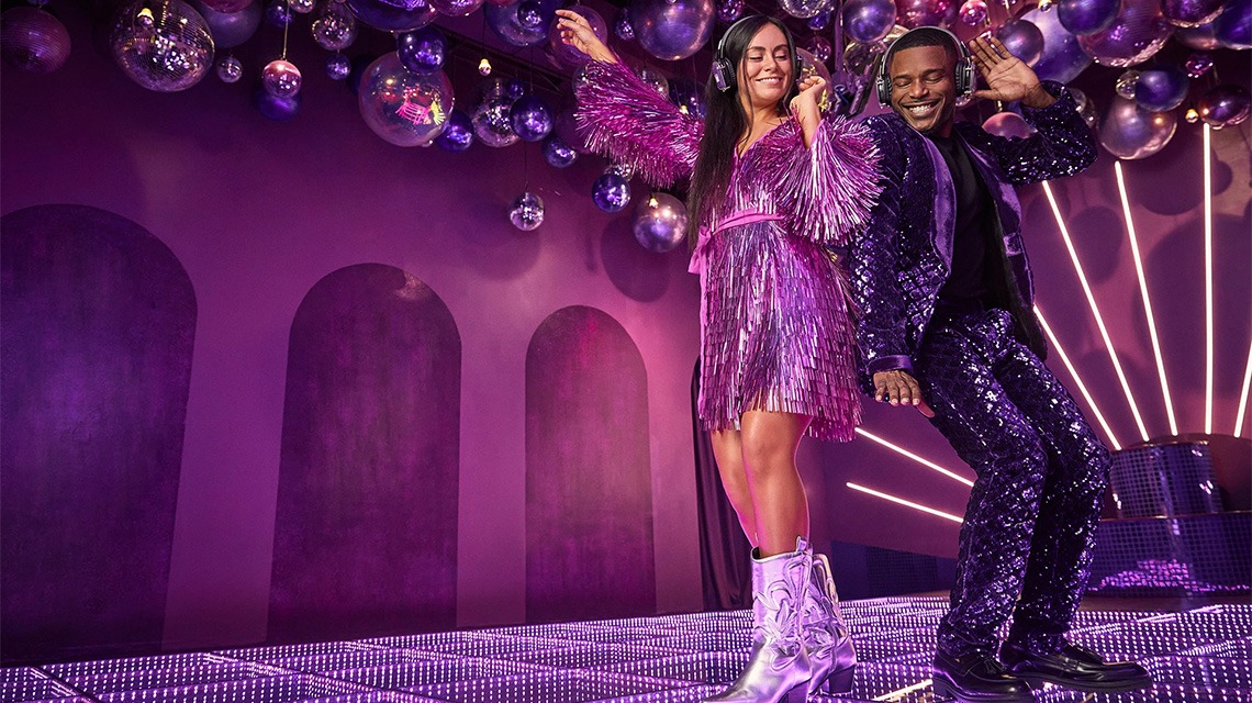 two dancers dressed in purple in purple room
