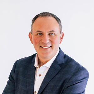 man wearing white dress shirt and blue coat