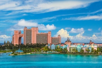 wide shot of ocean and large hotel in background