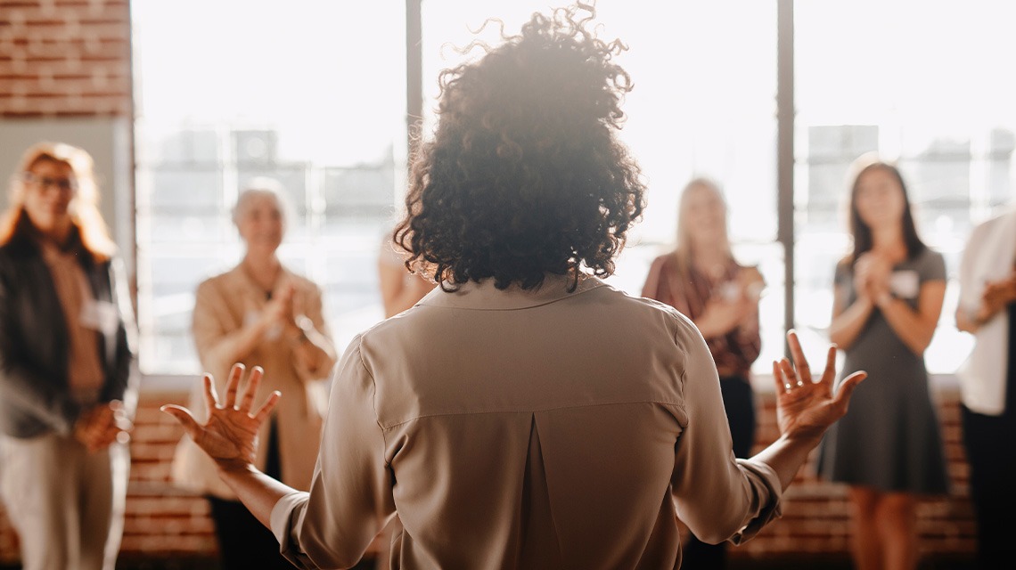woman speaking to small group of women