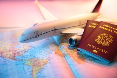 toy plane and passports sitting on top of map