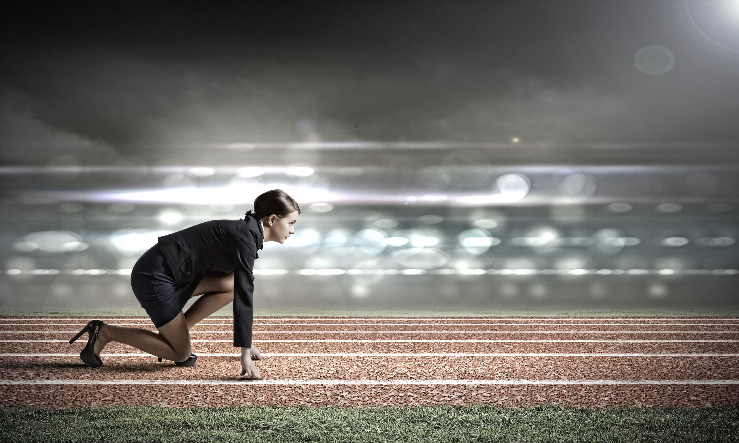 businesswoman at start of running track