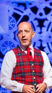 man wearing red plaid vest and white shirt