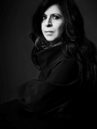 black and white portrait of woman in black coat
