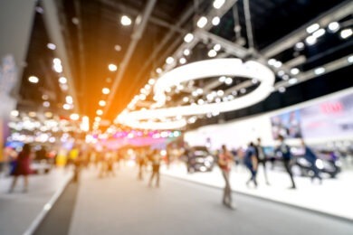 blurred image of people walking around convention center