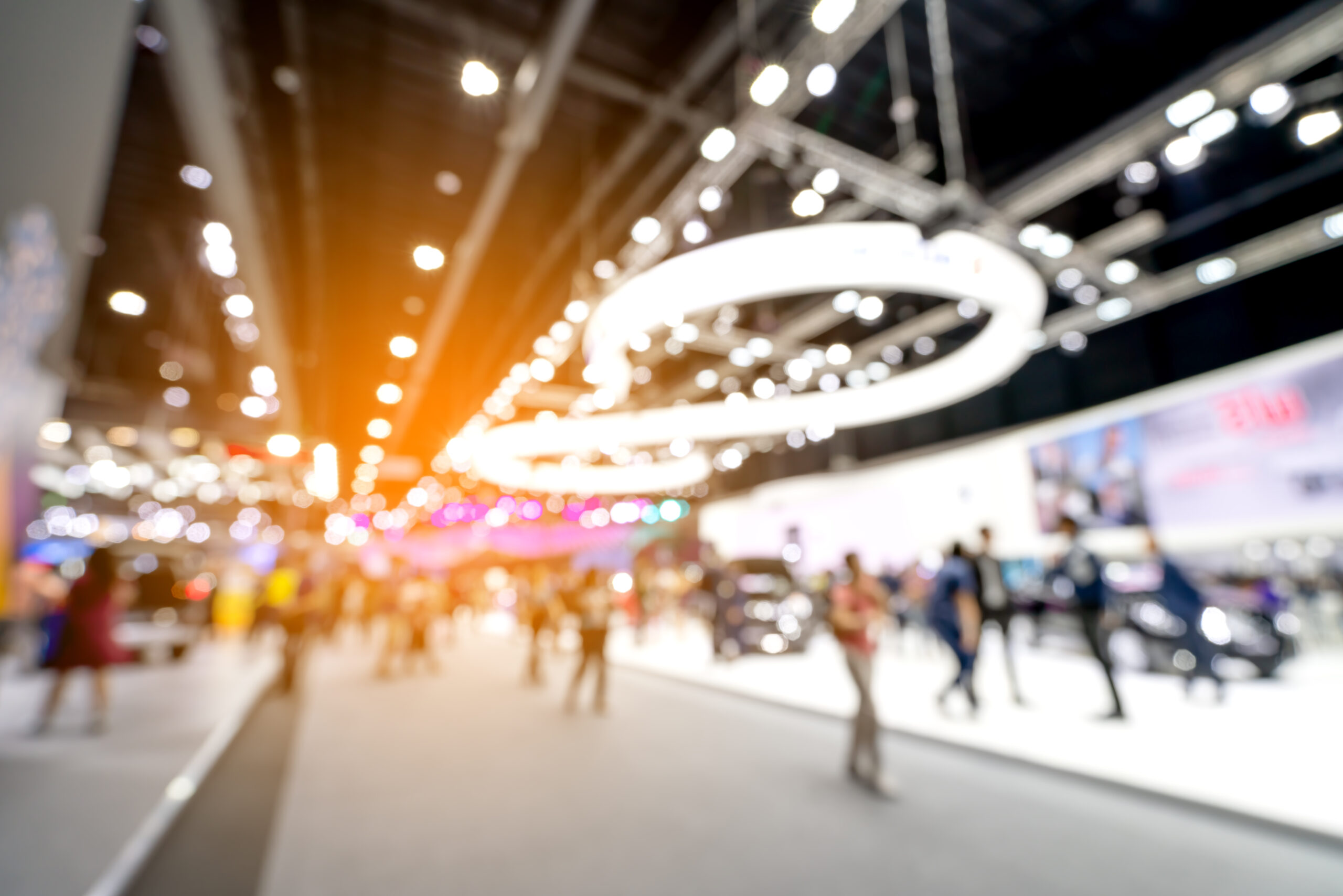 blurred image of people walking around convention center