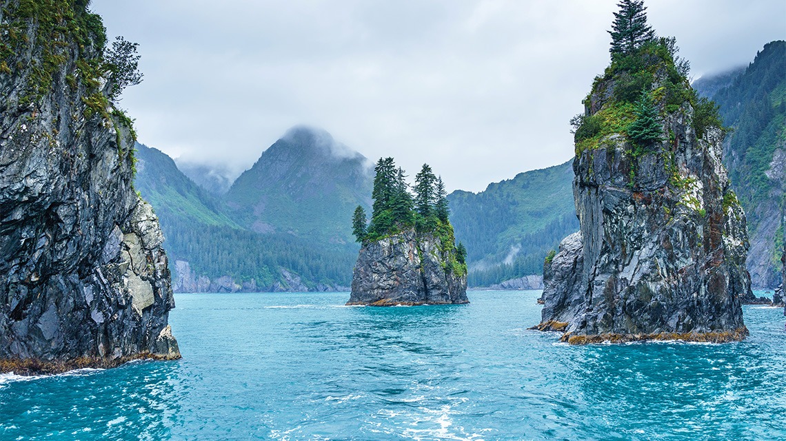 three large boulders in ocean