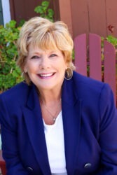 Karen Strgacich wearing blue sport coat and white shirt