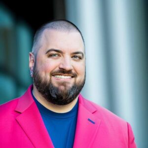 Nick Borelli in pink sport coat and blue shirt