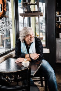 Santiago Corrada in black long sleeve shirt and blue scarf