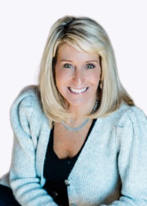 Beth Bushman waring light grey sweater and black shirt