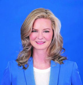 Gabrielle Weiss wearing blue sport coat and white dress