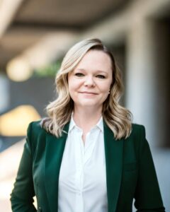Jennifer Little wearing green coat and white shirt