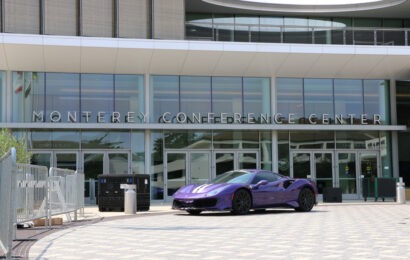 A bright purple Ferrari parked in front of the Monterey Conference Center