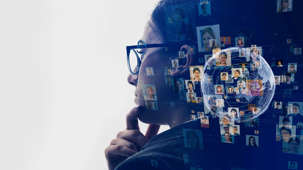 Woman in glasses next to headshots of various people