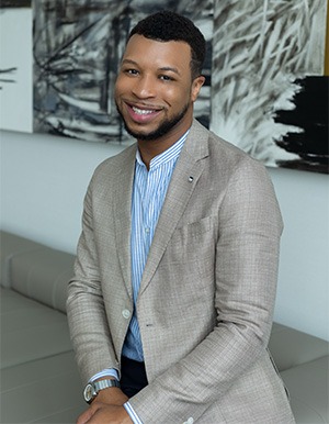 Brandon Avant in blue dress shirt and grey sport coat