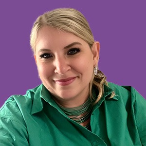 Kerry Latham wearing green shirt against purple background