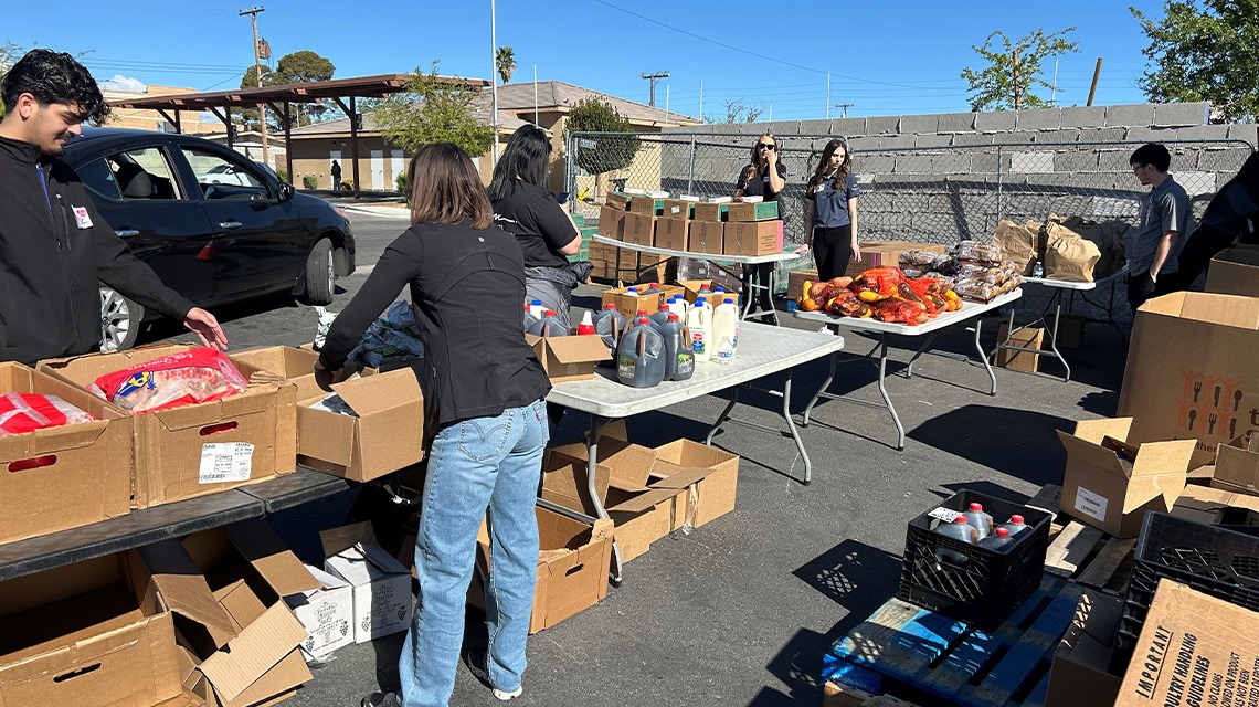 Hospitality professionals packing groceries
