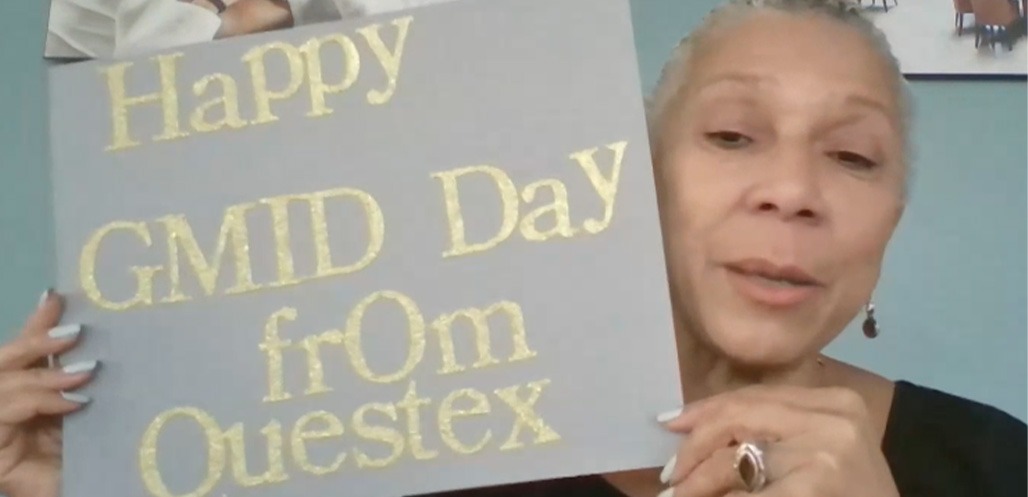 Woman holding GMID sign on livestream