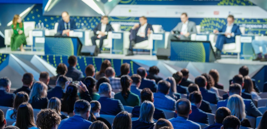 Large business conference with a speaker panel on stage