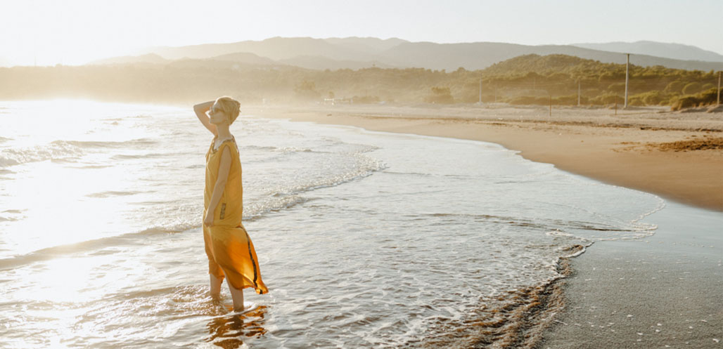 Woman in yellow dress at beach