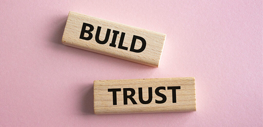 Wooden blocks that read "build trust"