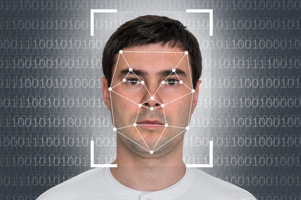 digital points on a man's face with 1 and 0 in background.