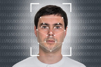 digital points on a man's face with 1 and 0 in background.