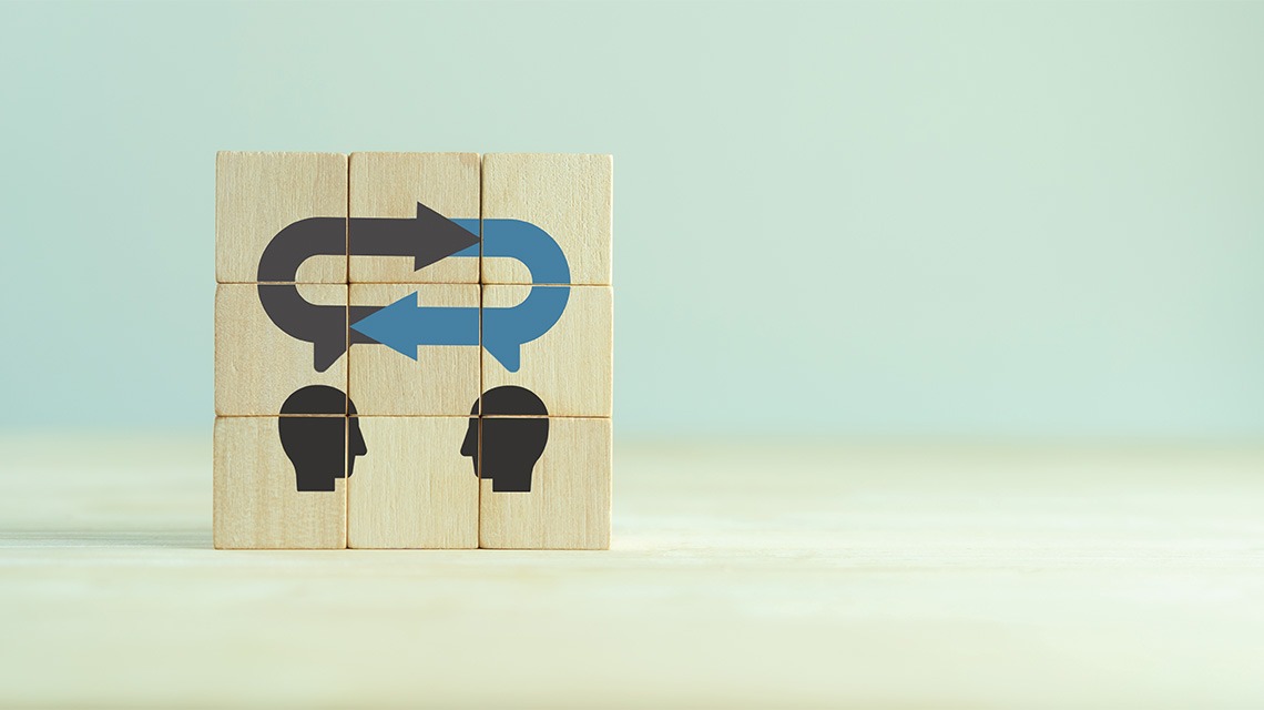 Two silhouetted faces on wooden blocks