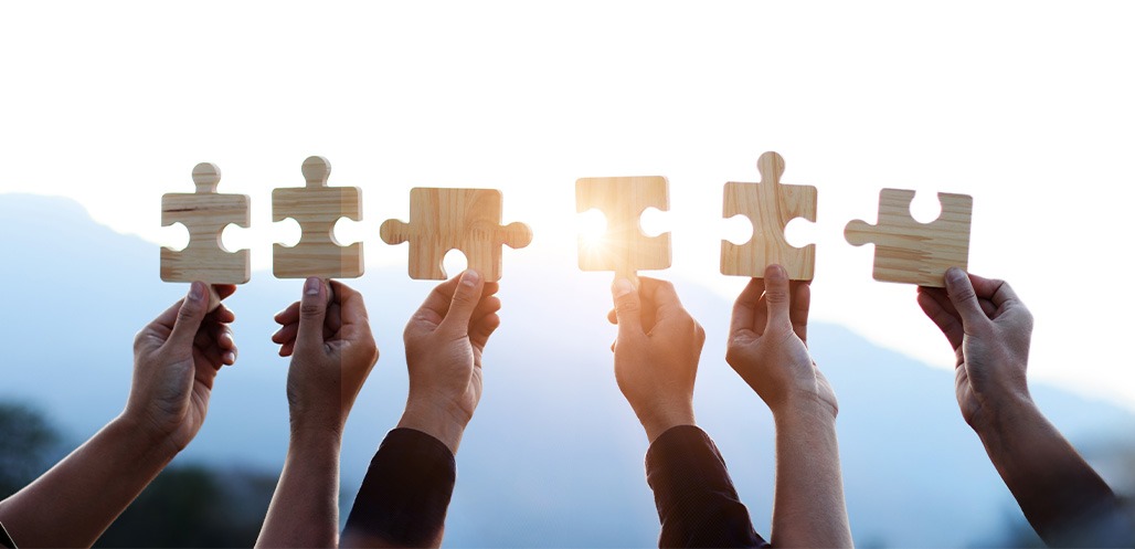 People holding up puzzle pieces