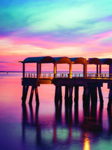 A beautiful ocean dramatic sunset and fishing pier at Jekyll Island in coastal Georgia, USA