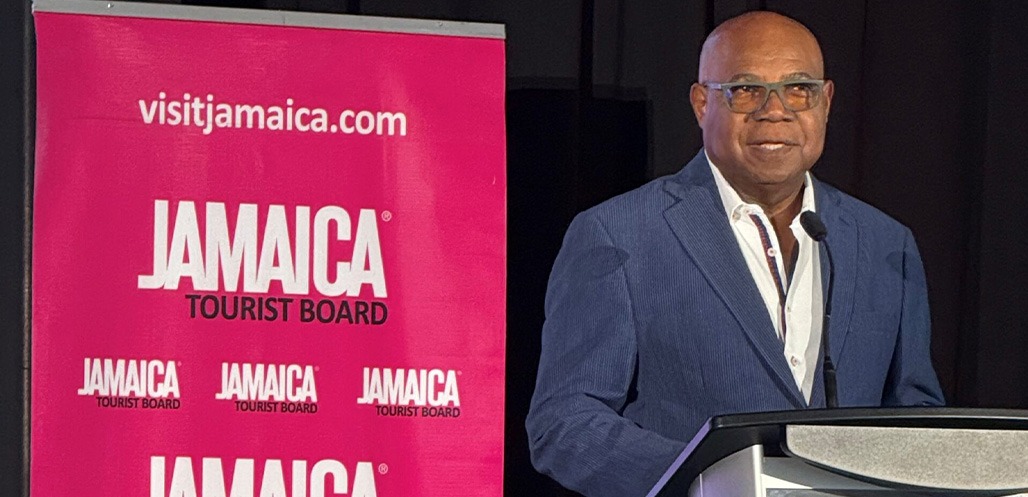 Minister Bartlett speaking on stage