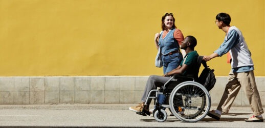 Person pushing someone in wheelchair