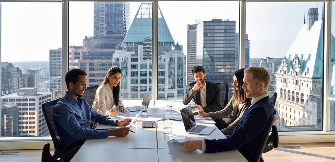 Five business professionals at desk