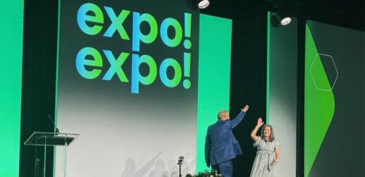 Two people on stage saying cheers