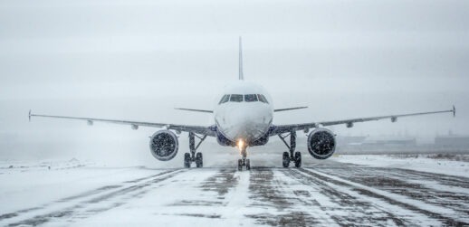 Plane on tarmac on snowy day