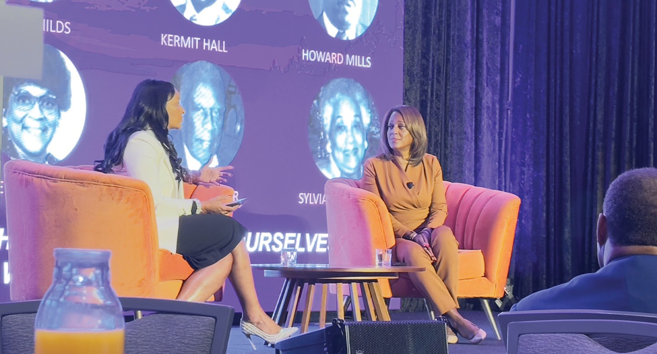 Two women talking on stage