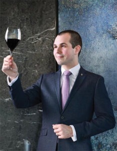 Jonathan Moran looking at glass of wine