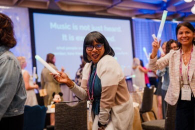 woman dancing in a conga line at a Smart Meetings Wellness Experience